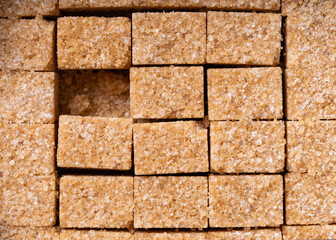 Brown sugar. Cane sugar cubes background. Cane sugar.