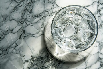 Glass of ice sitting on a marble table