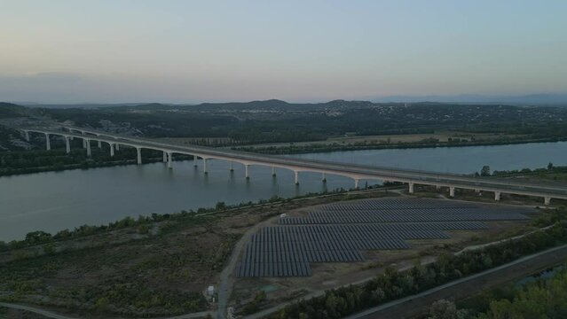 Panoramic aerial view of the double viaduct for high-speed passenger trains over the Rhône river in Avignon during sunset - France