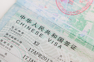 Close up of an approved Chinese visa on passport of foreign national, granting entry into China