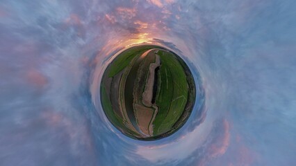 A tiny planet view of spectacular sunset over the River Waveney at Herringfleet, Suffolk, UK