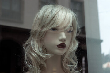 portrait on blond mannequin in a fashion store showroom