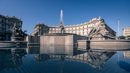 Fontana delle Naiadi at centre of Piazza della Repubblica with reflection of buildings, Rome, Italy