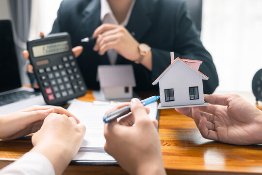 Real estate agent facilitated sale of property through mortgage loan, ensuring smooth investment process for purchaser with help of skilled broker. Concept of loan, insurance, approval, real estate.