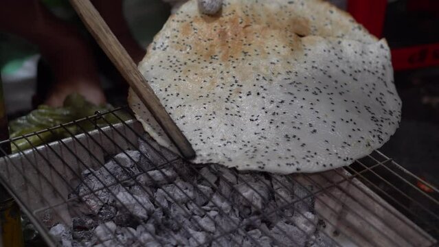 Grill rice paper on a charcoal stove, black sesame rice paper