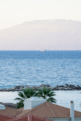 A cruise ship sailing in the sea against mountain in the place called Drosia in ths island of zakynthos in Greece