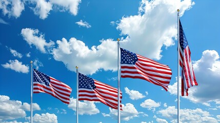 Obraz premium american flags waving in the wind against blue sky and clouds