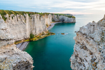 White chalk cliffs and natural arches of Etretat, Normandy, France. Atlantic sea coast in Normandie with famous rock formations at sunset. Long exposure. Travel destination - 790880607