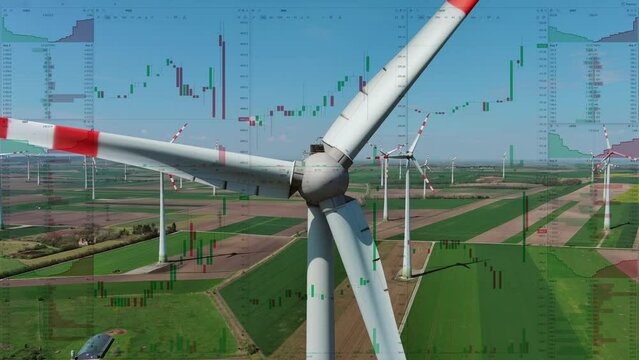 Wind turbines on the background of stock charts, aerial view. Green energy power production. Business financial concept, 4k