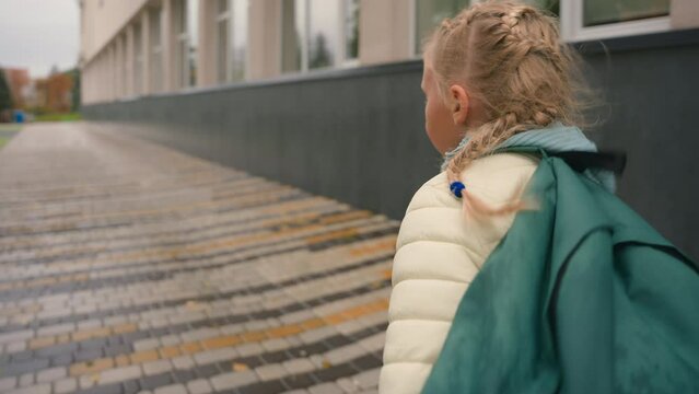 Back view little girl backpack run sidewalk city outside daughter offspring child childish schoolgirl learning hurry quickly kid pupil jog weekend fast active game playful energetic education studying
