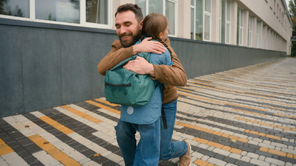 Little girl running dad back to school schoolgirl student happiness joy hug family learner kid...