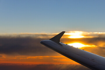 Wing of a holiday jet against a sunset sky