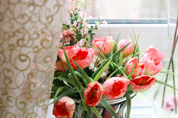 Artificial flowers on the windowsill