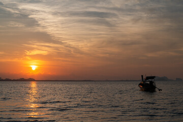 beautiful sky on sunrise with fishing boat at Koh mook.Trang, Thailand.