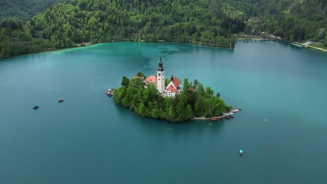 Aerial view Pilgrimage Church of the Assumption of Maria on a small island, Bled lake, Slovenia, 4k