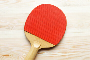 Ping pong racket on wooden background. Stay home concept