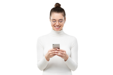 Young woman in glasses, holding phone in hands, typing message with happy smile