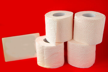 Toilet paper rolls and message Stay Home on bright red background. Quarantine concept