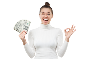 Young woman feeling excited because of her victory in lottery, holding fan of hundred 100 dollar banknotes, showing ok gesture