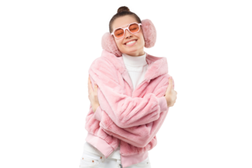 Young girl in pink fur coat, earmuffs and eyeglasses, embracing herself as if dancing and enjoying free time