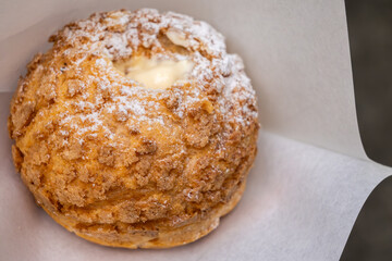 Taiwanese custard cream puff covered in powdered sugar.