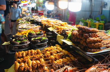 A stall with various delicacies at the night market in Vietnam