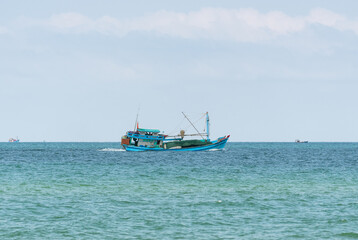 A fishing boat under the flag of Vietnam sails across the sea to the fishing spot