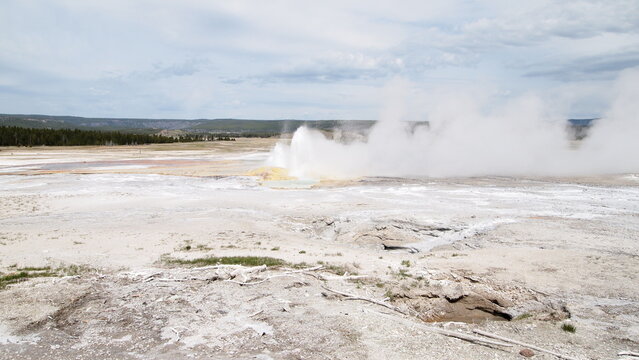 Grand prismatic spring with hot spring geyser in a national park
