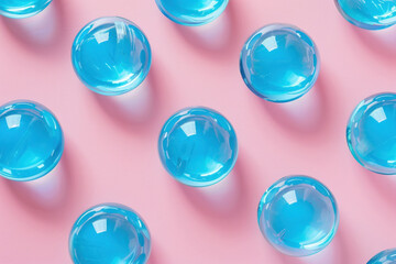 Fototapeta premium Beautiful Blue Glass Balls Arranged on Vibrant Pink Background with Blue Sky, Creative Decor Concept