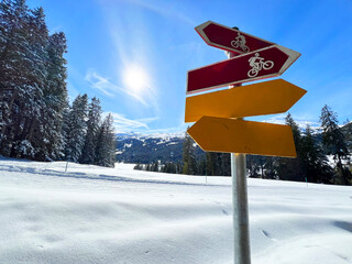 Hiking markings and orientation signs with signposts for navigating in the idyllic winter ambience...