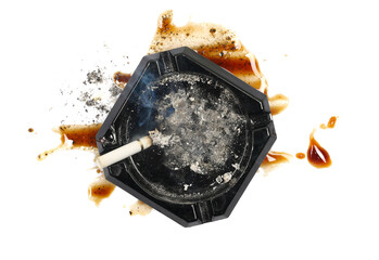 Lit cigarette in black ashtray and spilled coffee espresso with foam, stains isolated on white...