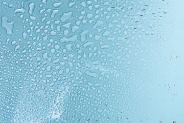 Blue backgrond with water drops. Wet glass.