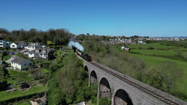 Broadsands, Torbay, South Devon, England: DRONE VIEWS: A steam train on route to Kingswear on the Torbay Steam Railway line. The steam trains are a major tourist attraction for UK holidaymakers.