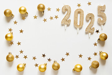 Golden Christmas balls and candles numbers 2025 on a light white background. Festive xmas decoration gold stars confetti. Empty space for copy space in the center