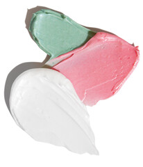Pink and white and green cream smears on empty background