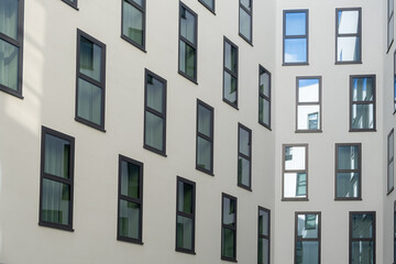 Fototapeta premium Windows adorn the wall of a modern home, architectural design. City living spaces.