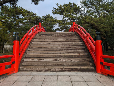 the red wooden drumbridge overlooking the steps at sumiyoshi temple in osaka