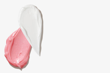 Pink and white cream smears on empty background