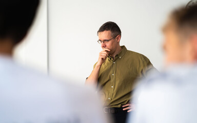 white caucasian Lecturer with glasses in class, military shirt