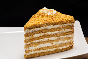 White plate holding a slice of cake, a staple food in baked goods cuisine