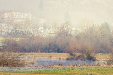 The Brenz river between Königsbronn and Heidenheim in Germany on an early spring day. Cold, foggy, snowy weather.