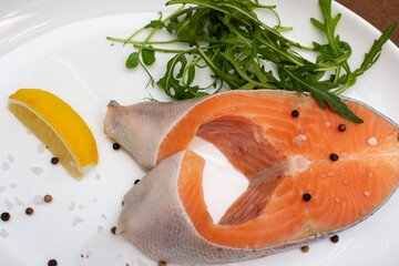 Seafood dish with salmon and citrus on white plate