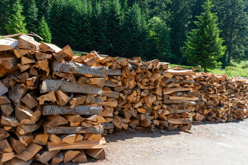 Wood logs are neatly piled on top of each other in a stack