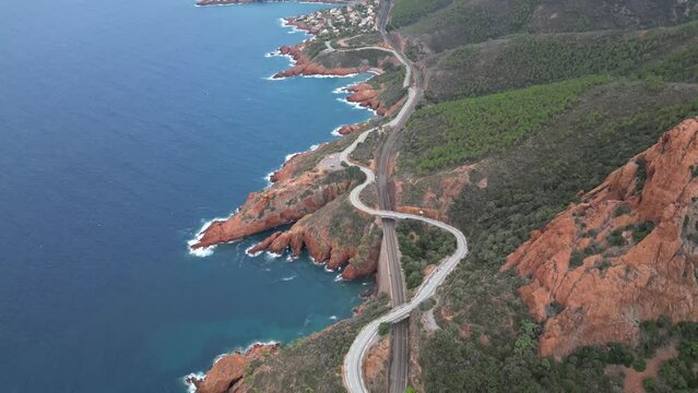 Aerial view of the Massif de L'Esterel and a beautiful winding road over the cliffs falling into the Mediterranean Sea. French Riviera. Cote d'Azur
