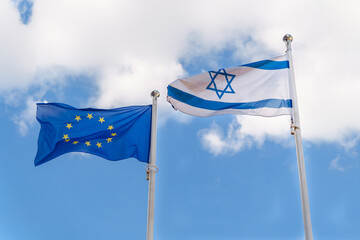 Flags of Israel and the European Union waving together in the sky, symbolizing international...