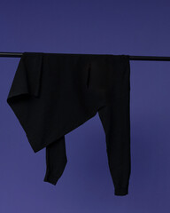 Longsleeve hangs on a purple BACKGROUND