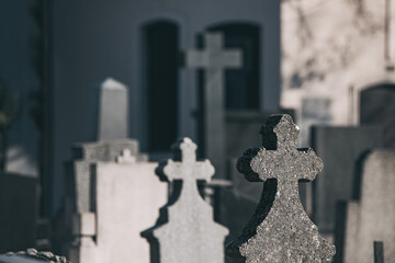 Amidst the quiet serenity of the cemetery, rows of tombstones and crosses stand as solemn monuments...