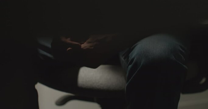 Nervous Man's Hands Fidgeting, Legs Shaking, While In Police Interrogation Room or Job Interview. Confession to Crime. Interview Room