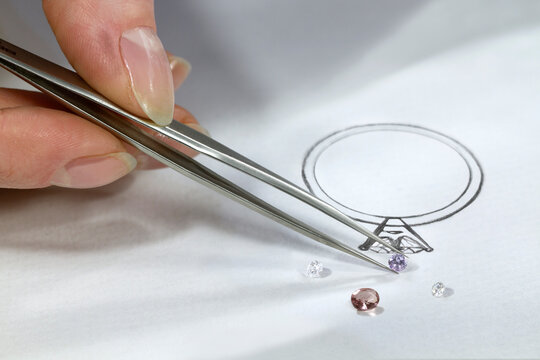 The work of a jeweler-designer. A jewelry designer develops sketches of jewelry. Design studio. Creative ideas.
