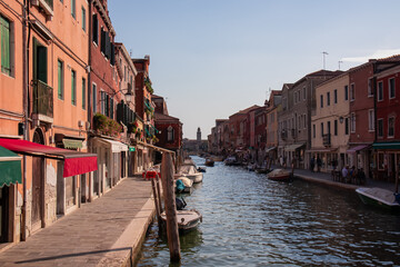 Panoramic view of small water channel on Murano island in city of Venice, Veneto, Italy, Europe. Venetian architectural landmarks and old houses facades along the man made water traffic corridor - obrazy, fototapety, plakaty